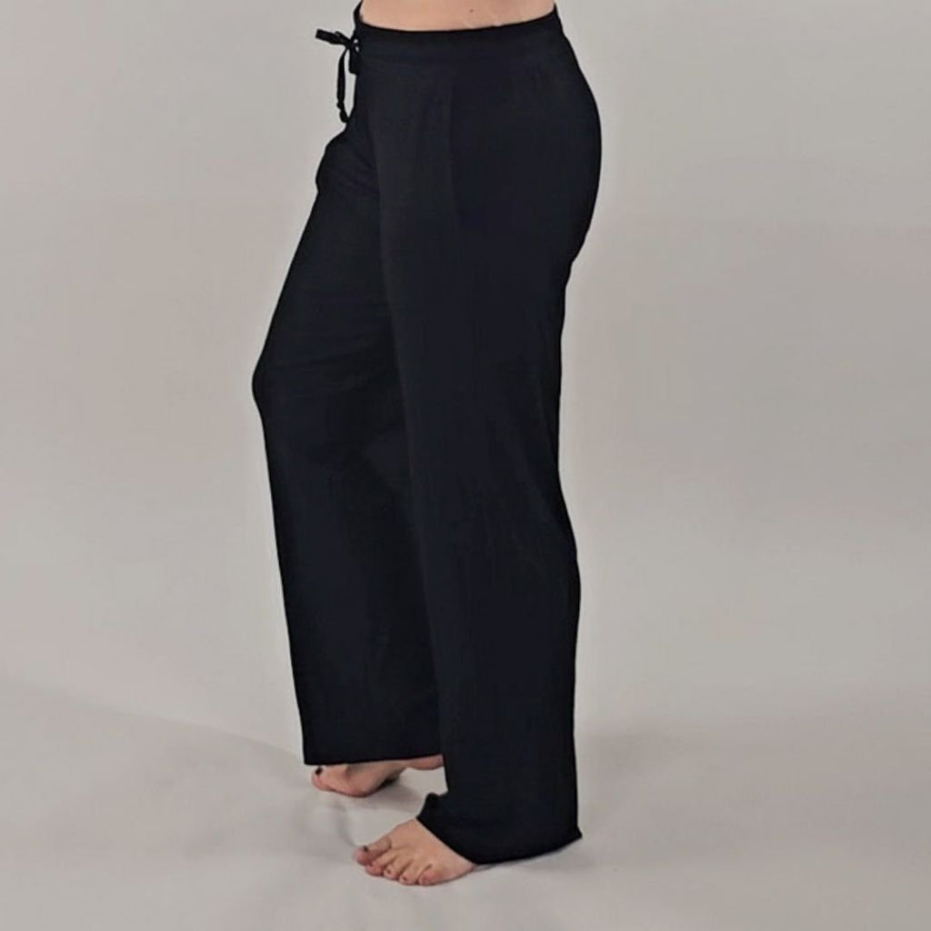 A woman wearing black ribbed wide-leg pants with a relaxed fit.