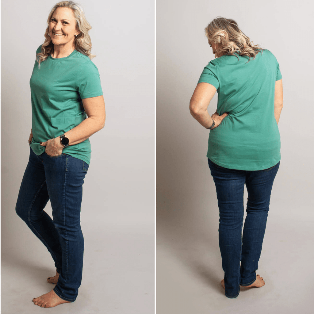 A woman wearing a relaxed fit crewneck shirt in cadet blue color. shown in size medium