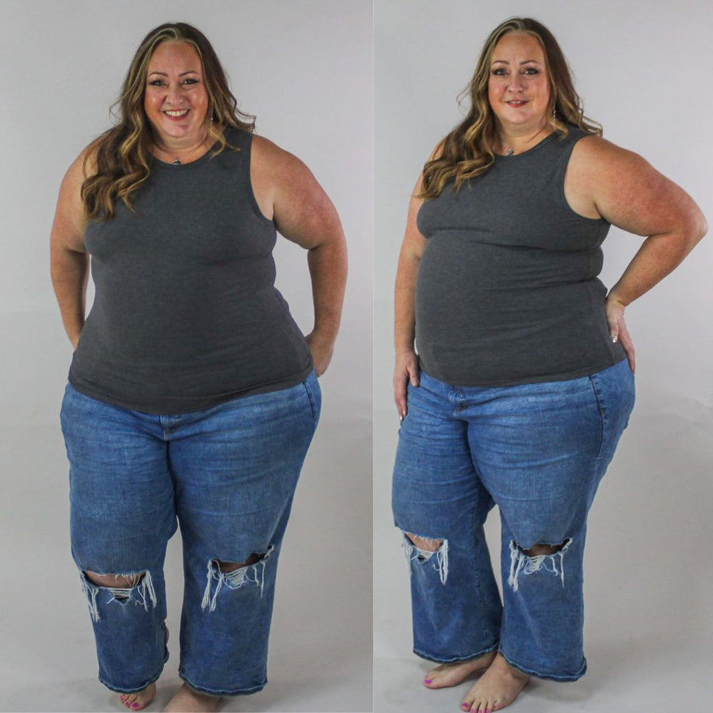 A woman wearing a dark grey ribbed high neck tank top. shown in size 2XL