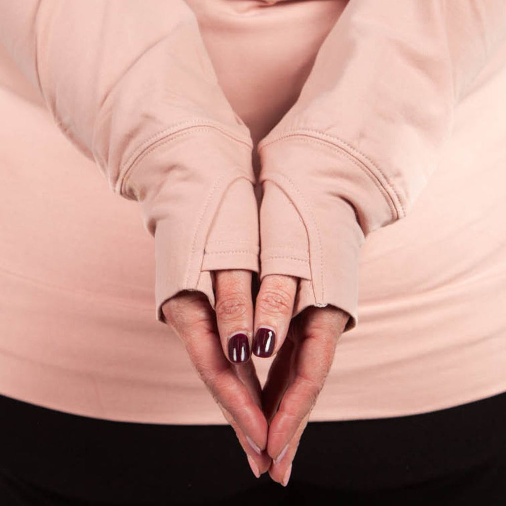 detail view of pink long sleeves that have thumbholes.