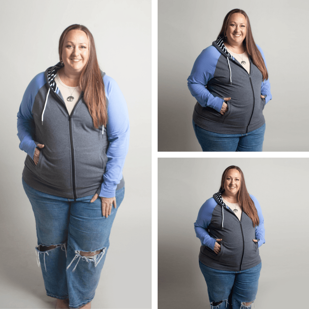Woman wearing a gray and blue hoodie with side pockets, and a black and white striped pattern on the hood and thumbholes. shown in size 3XL