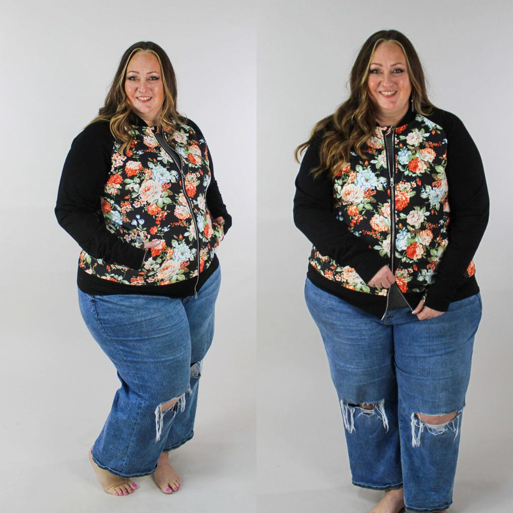 A woman wearing a floral print hoodless jacket with a stand collar, full front zipper, black sleeves, and floral  thumbholes. shown in size 3XL