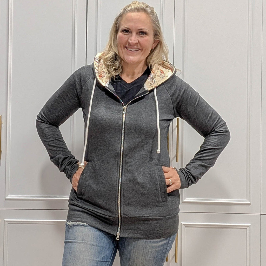 Meadow Fullzip - Women's fashion hoodie color block grey body with cream floral print accented hood and thumbholes. Features double zipper for curvier fit, feminine tailored, side pockets, and hood shown in M women