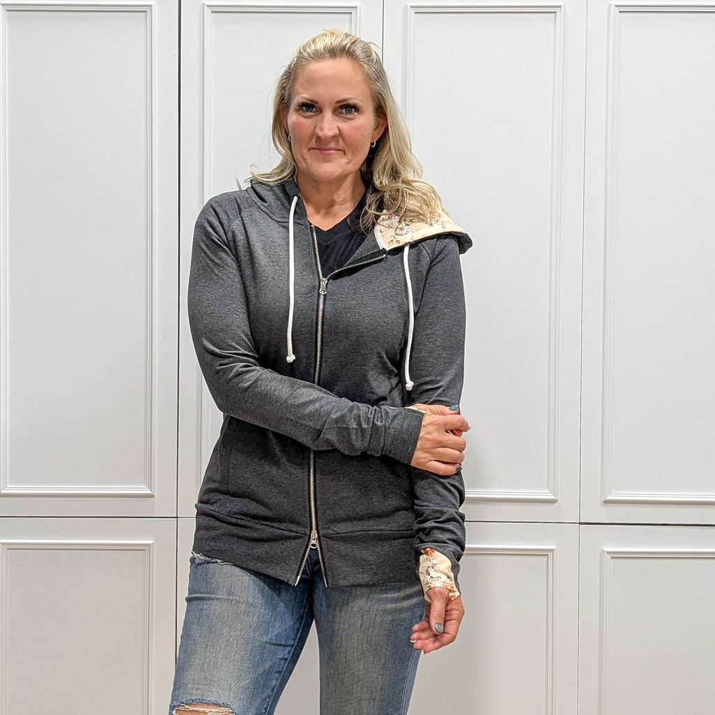 Meadow Fullzip - Women's fashion hoodie color block grey body with cream floral print accented hood and thumbholes. Features double zipper for curvier fit, feminine tailored, side pockets, and hood shown in M women