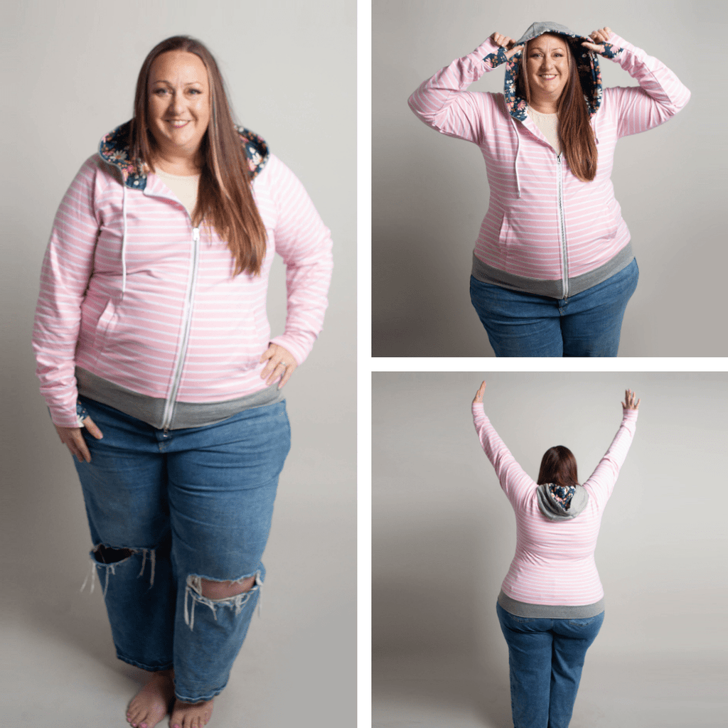 Woman wearing a pink striped hoodie with a floral lined hood, thumbholes, and double zipper. shown in size 3XL