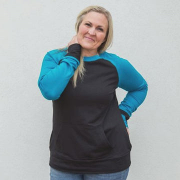 Brooklyn Crew Neck video, womens crew neck clothing, longer body, longer sleeves, watch hole, thumbholes, black with blue sleeves, royal blue, kangaroo pocket - Shop7degrees