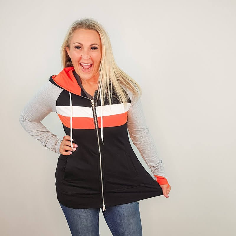 ridgevue-full-zip-Women's fashion hoodie color block Black body with Dark orange and white stripe accented sleeves with heather grey and dark orange in the thumbholes and hood. Features double zipper for curvier fit, feminine tailored and hood shown in M women