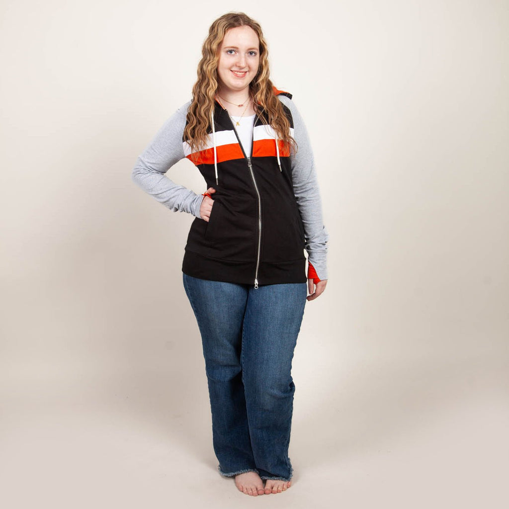 ridgevue-full-zip-Women's fashion hoodie color block Black body with Dark orange and white stripe accented sleeves with heather grey and dark orange in the thumbholes and hood. Features double zipper for curvier fit, feminine tailored and hood shown in M women