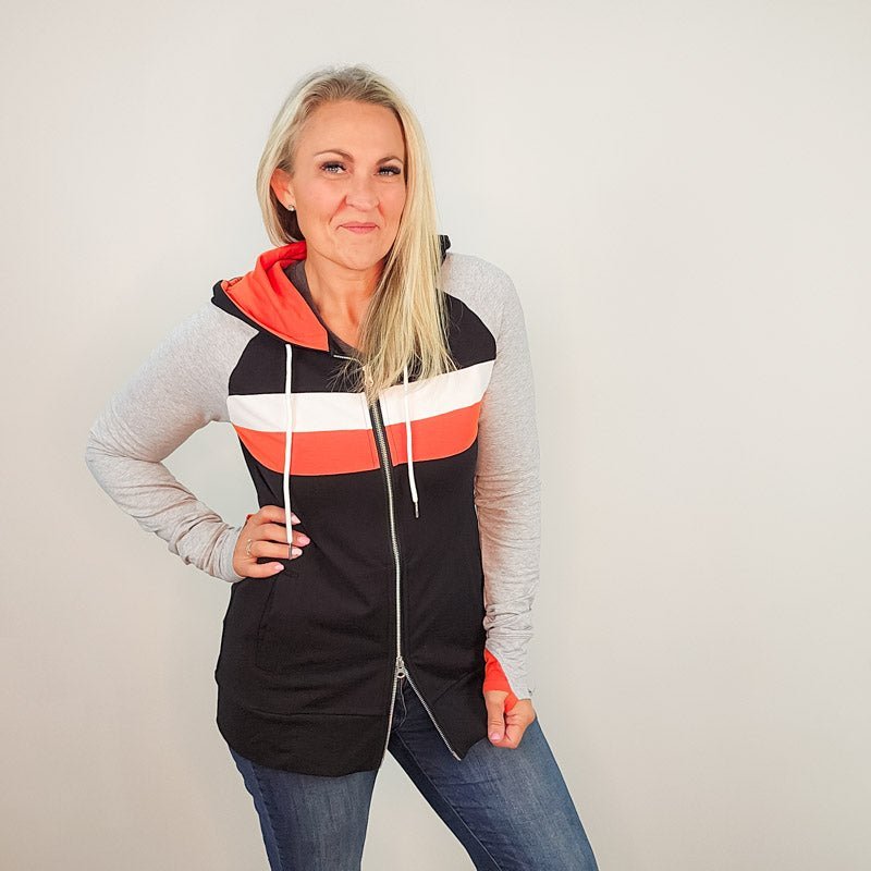 ridgevue-full-zip-Women's fashion hoodie color block Black body with Dark orange and white stripe accented sleeves with heather grey and dark orange in the thumbholes and hood. Features double zipper for curvier fit, feminine tailored and hood