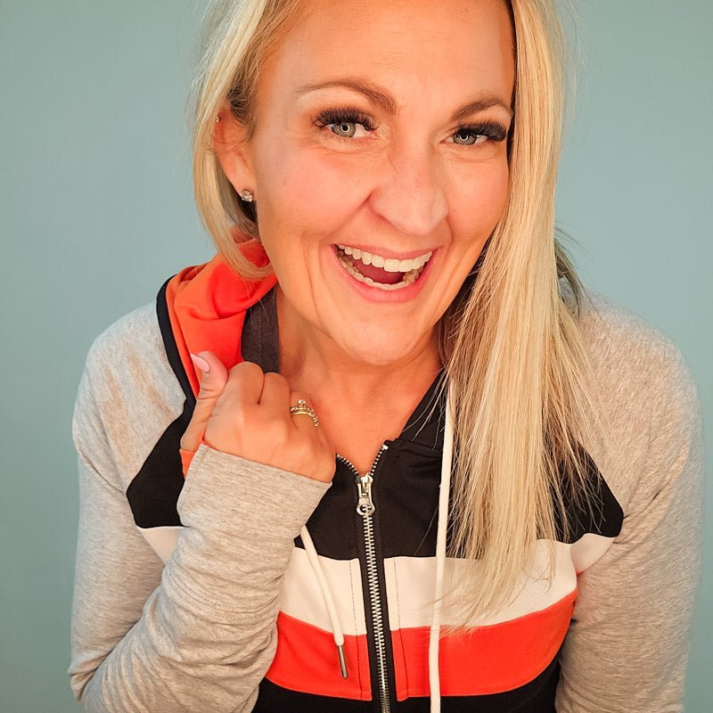 ridgevue-full-zip-Women's fashion hoodie color block Black body with Dark orange and white stripe accented sleeves with heather grey and dark orange in the thumbholes and hood. Features double zipper for curvier fit, feminine tailored and hood