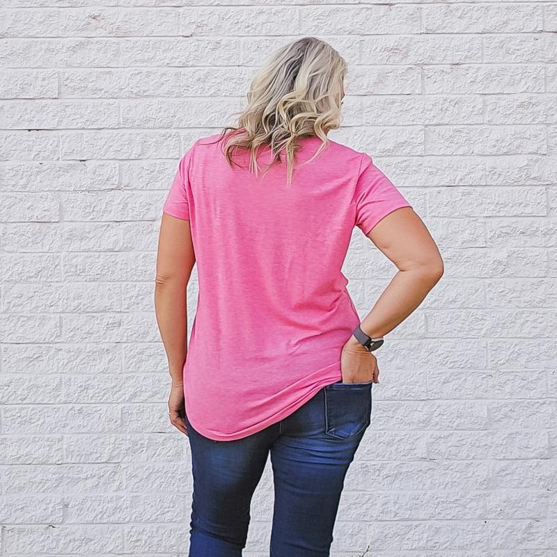 A woman wearing a heather pink, short-sleeved crew neck shirt. shown in medium