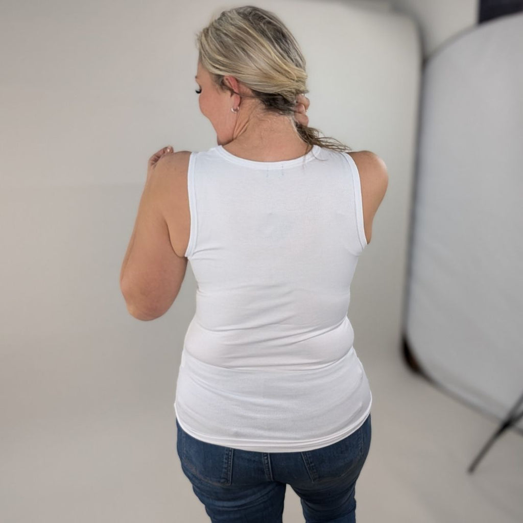 A woman wearing a white high-neck ribbed tank top. shown in size medium